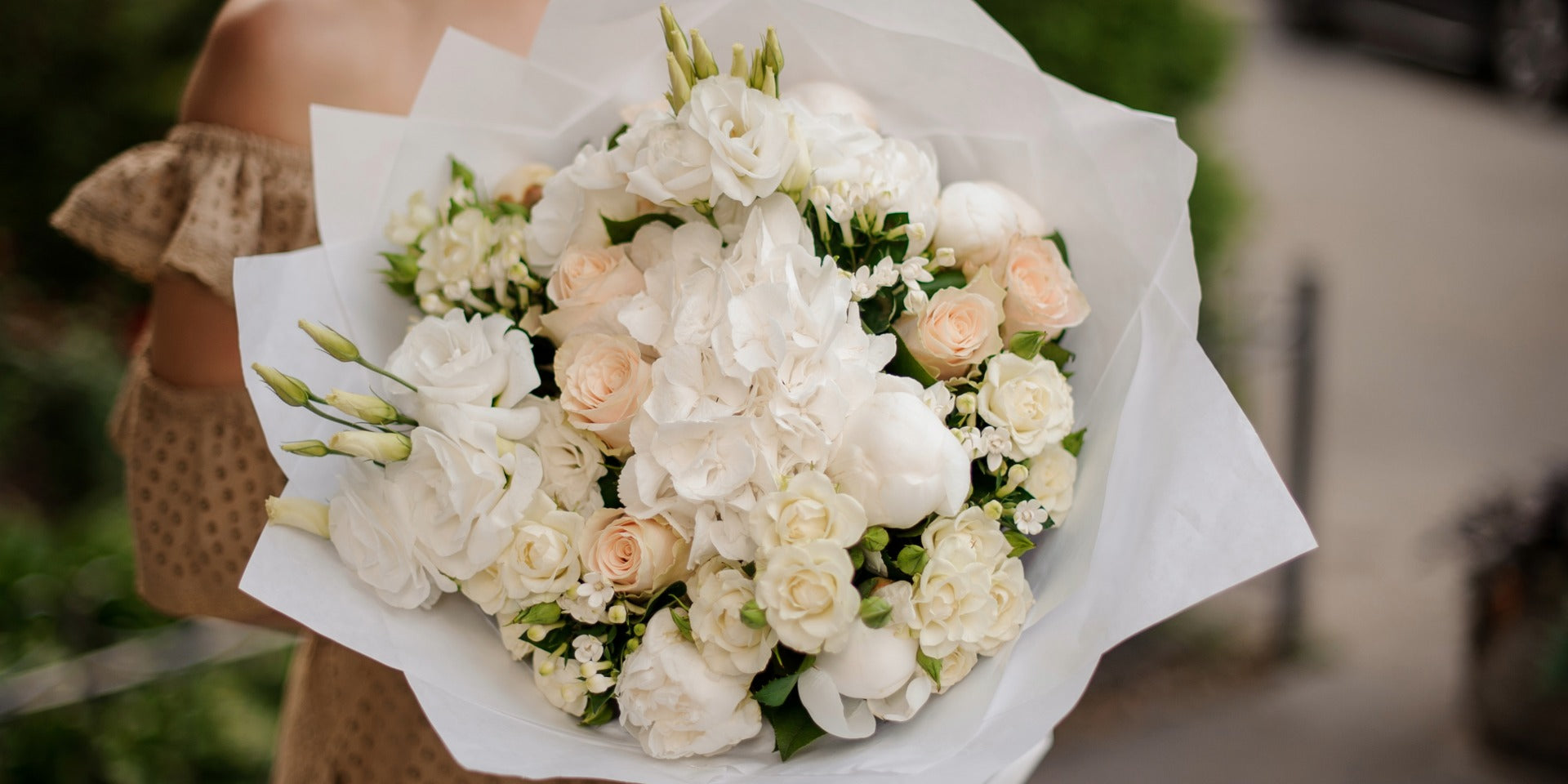 Luxury white and blush flower bouquet for delivery in Los Angeles featuring hydrangea, roses, lisianthus, and peonies.