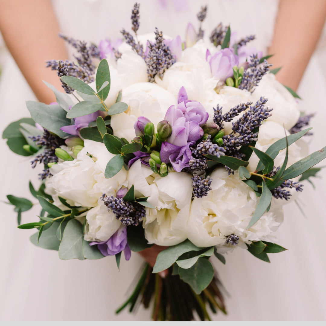 Soft and romantic bridal bouquet with lavandin, white peonies, and crocus flowers in a garden-inspired design