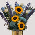 Celebration of life floral tribute with sunflowers, blue delphinium, and white roses inspired by a watercolor artist’s palette by Pearson Floral Designs.