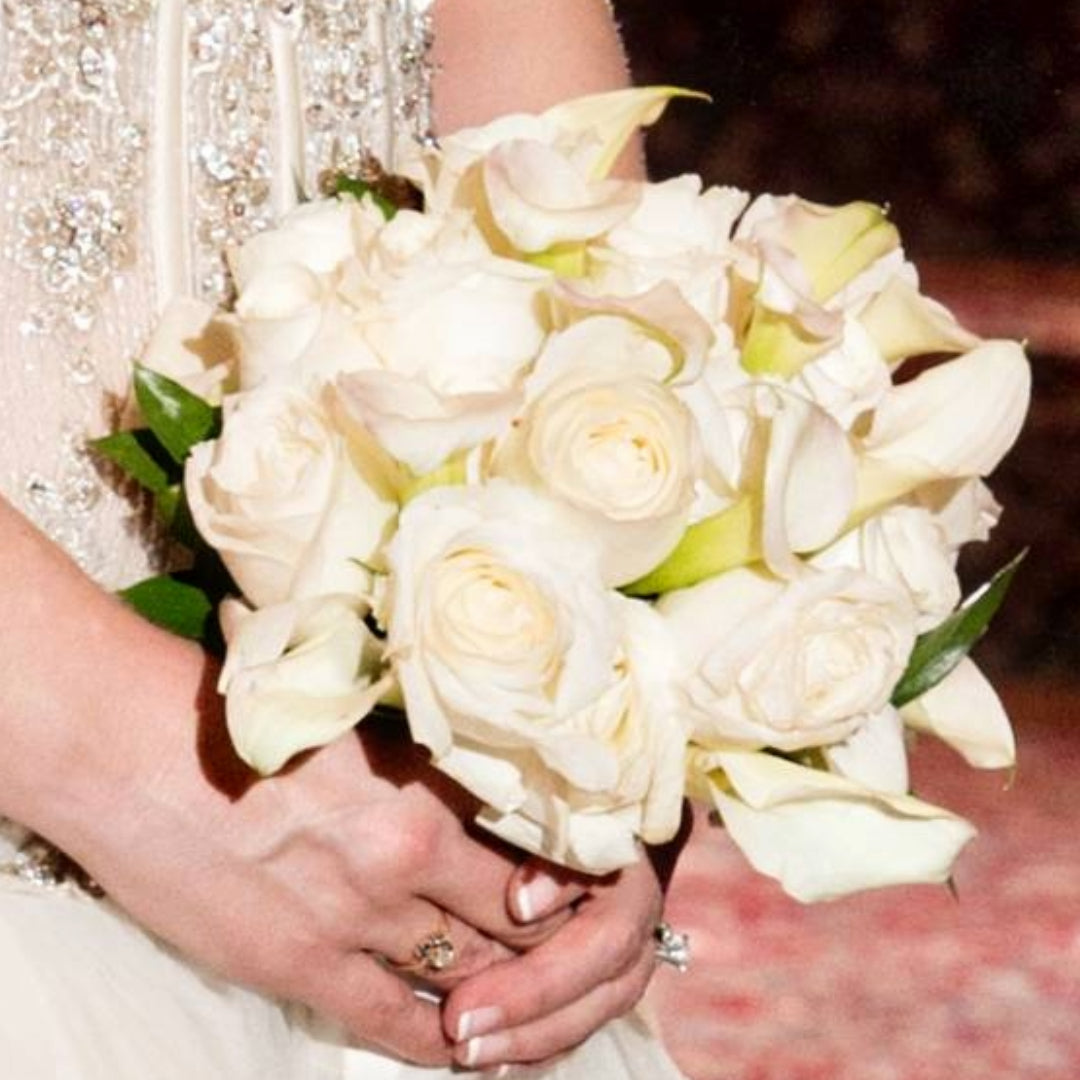 Elegant white bridal bouquet with roses and calla lilies in a timeless, classic design