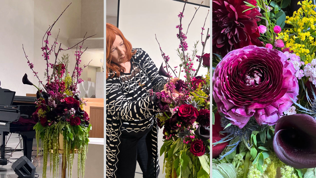 dark and moody floral arrangement for concert stage featuring dahlias, ranunculus, calla lilies, blue thistle, and gypsum