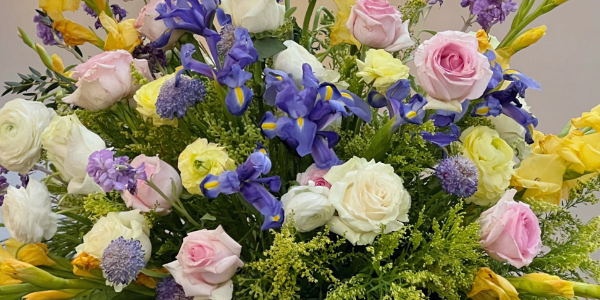 gold-gladiolas-purple-irises-yellow-ranunculus-banner-arrangement