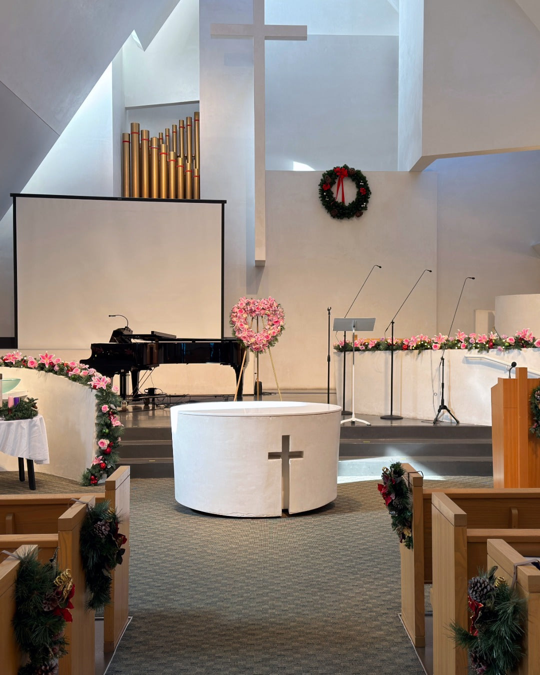 Christmas season celebration of life with pink lilies and lavender roses incorporated into holiday decorations.