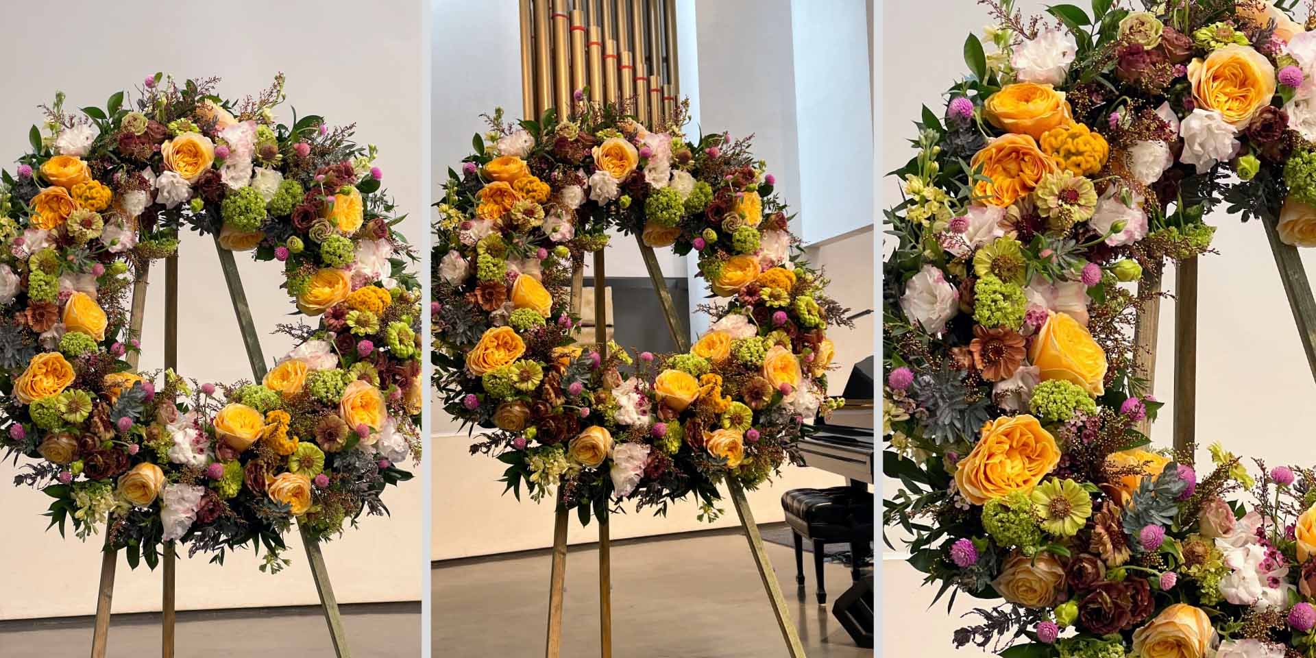 Floral wreath in soft yellow and peach tones honoring a life well-lived by Pearson Floral Designs, Los Angeles.