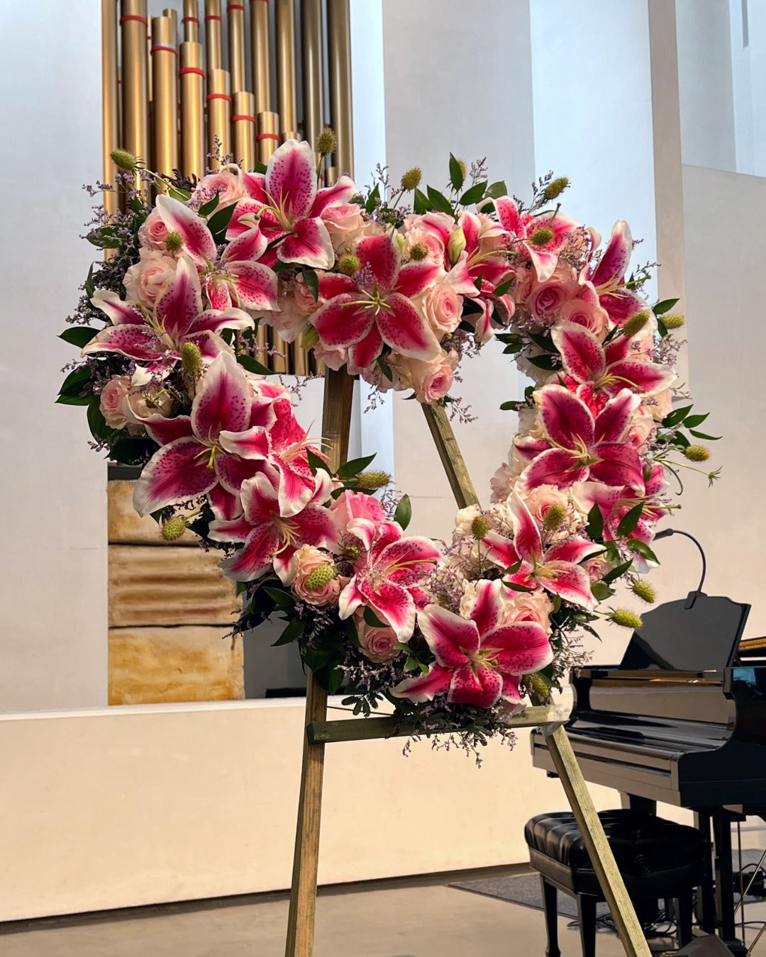 Open heart wreath with stargazer lilies and Vendala pink and white roses for celebration of life service.