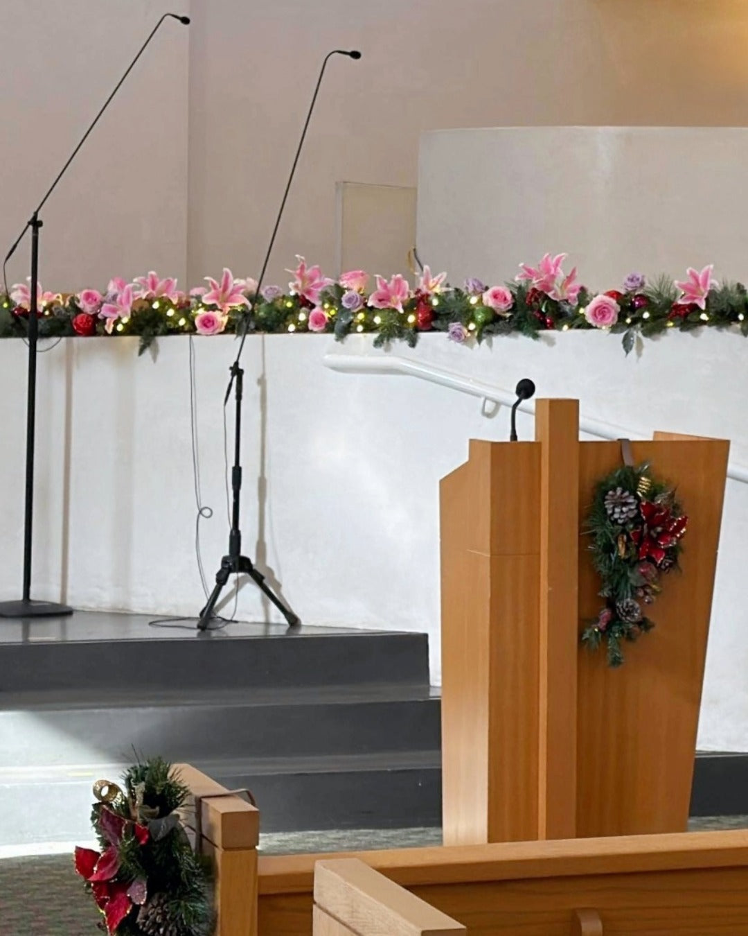 Pink lilies and lavender and pink roses incorporated into Christmas garland for celebration of life service.