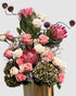 Luxury garden-style arrangement with protea, roses, antique hydrangeas, delphinium, and dancing allium.