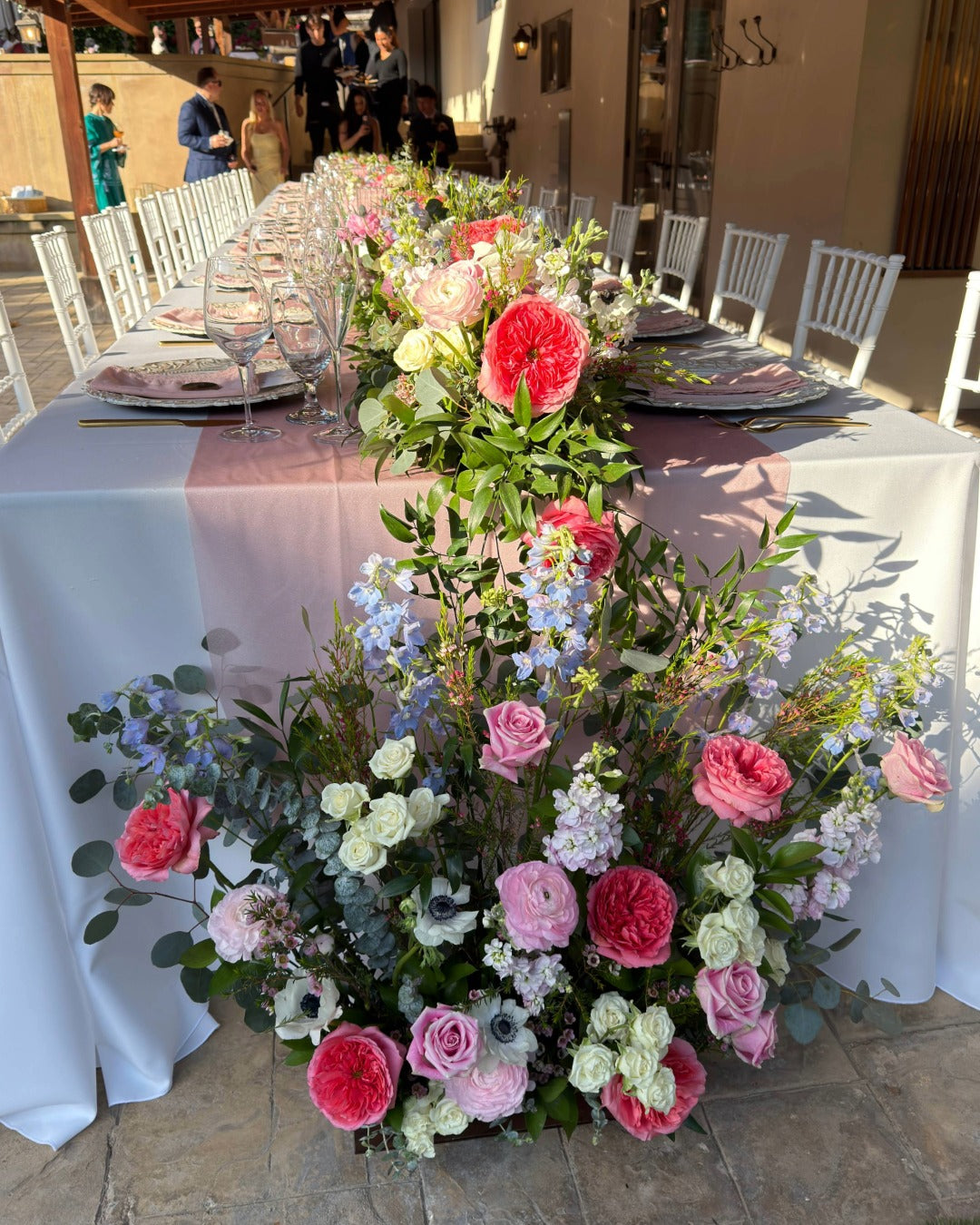 Santa Barbara vow renewal 40 foot garden-style floral table runner in pink, lavender, white and blue.